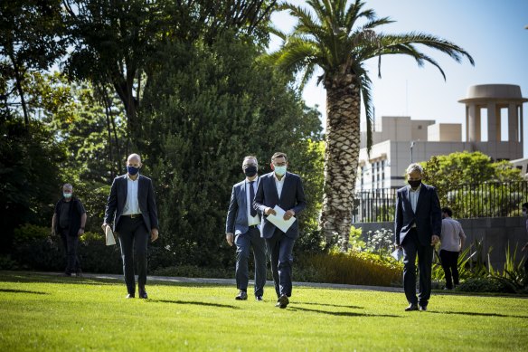 From left: Covid-19 response commander Jeroen Weimer, Health Minister Martin Foley, Premier Daniel Andrews and Chief Health Officer Brett Sutton arrive in Parliament Gardens to announce the lifting of a “circuit-breaker” lockdown.