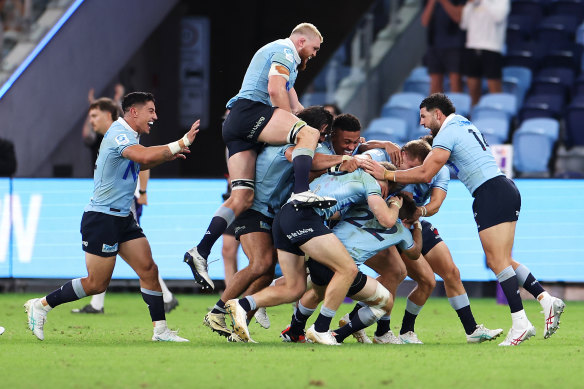The Waratahs celebrate their 43-40 win over the Crusaders.