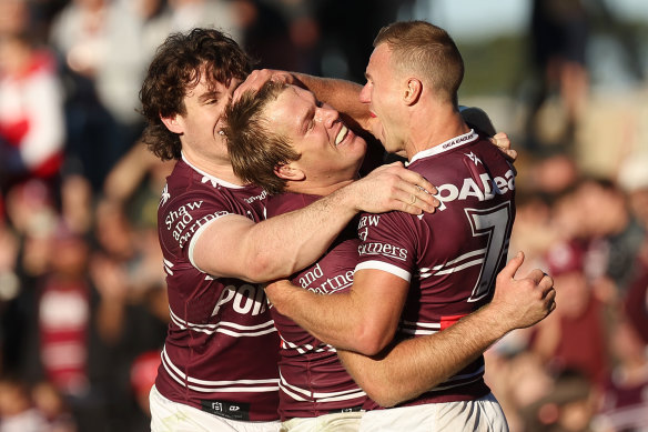 Jake Trbojevic and Daly Cherry-Evans celebrate a try against the Dragons on Sunday.