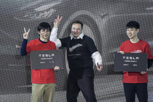 Tesla CEO Elon Musk with car owners at the company’s Shanghai factory. in 2020. 