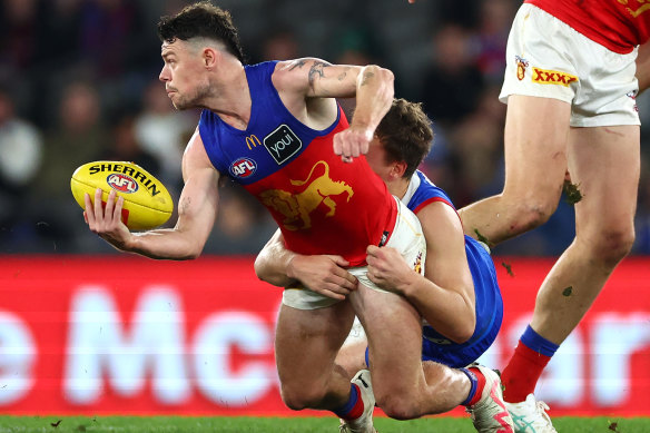 Lions star Lachie Neale is tackled by the Bulldogs’ Jack Macrae.