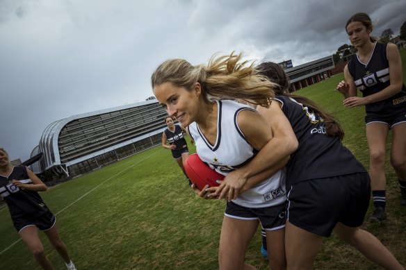 Sports researchers and a growing numbers of female AFL players, including Francesca, Abby, Piper, (getting tackled) Sofia, Jasmine and Grace from the Caulfield Grammar firsts team, and parents are arguing for more awareness of breast protection on the field.