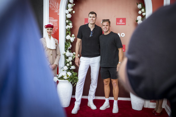 Mason Cox (left) and fellow Collingwood footballer Dan Houston in the Emirates marquee at the Australian Open on Tuesday. 