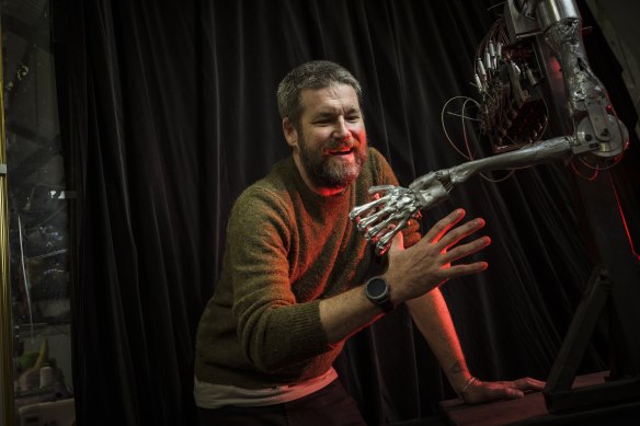 Robot, paper, scissors: Joe Blanck with the robotic arm he has helped design for Melbourne Knowledge Week.