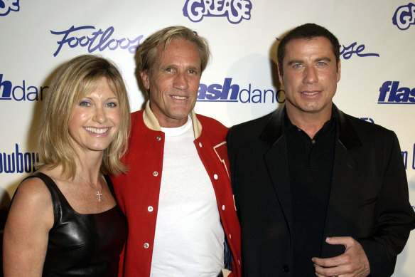 Randal Kleiser, centre, with Newton-John and John Travolta in more recent years.