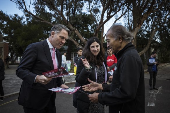 Deputy Labor leader Richard Marles hands out how-to-vote cards on Monday with the ALP’s Chisholm candidate, Carina Garland, at a church in Mount Waverley.