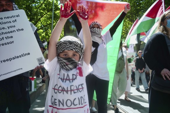 A child attends the pro-Palestine protest in Melbourne on Sunday.