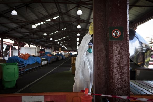 Stalls at Queen Victoria Market being cleaned after it was listed as an exposure site by the Department of Health.