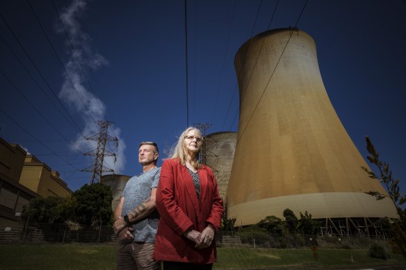 Latrobe Valley residents Wendy Farmer and Tony Wolfe, pictured near the Yallourn Power Plant, advocate for transition away from fossil fuels to renewable energy.