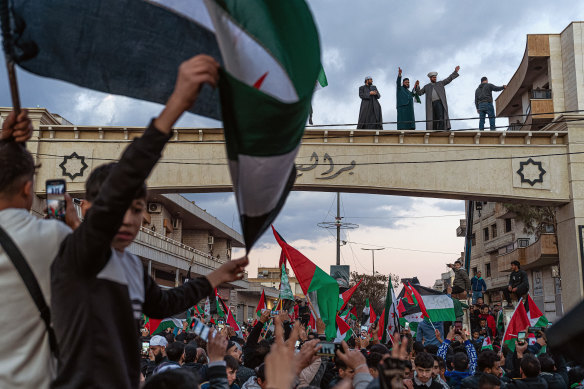 Hundreds of Sunni Muslims gather in celebration, marking the fall of Bashar al-Assad’s long and brutal reign in Syria, on a road leading to the Lebanon-Syria Masnaa border crossing in Bar Elias, Lebanon.