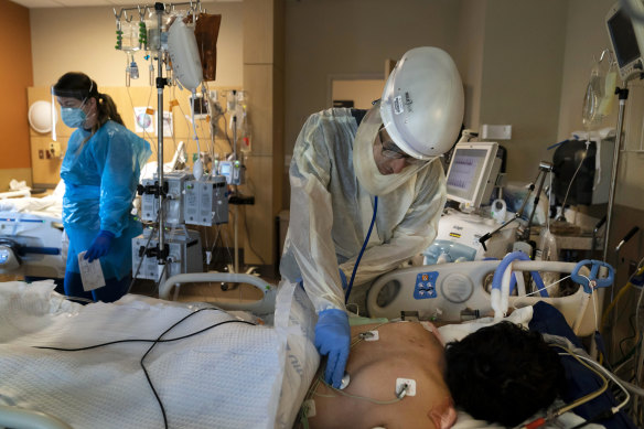 A doctor checks on a COVID-19 patient at a hospital in Los Angeles.
