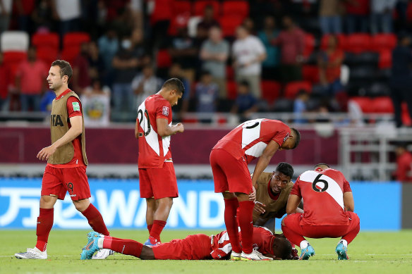 Peruvian players distraught after Andrew Redmayne saves the crucial penalty.