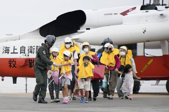 Residents of the islands arrive at a heliport in Kagoshima, southern Japan, to take refuge ahead of a powerful typhoon. 