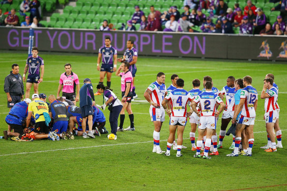 Knights players huddle as medical staff attend to Alex McKinnon at AAMI Park on March 24, 2014.