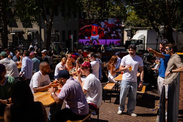 People gather at The Clock hotel on Crown Street to watch the AFL grand final.