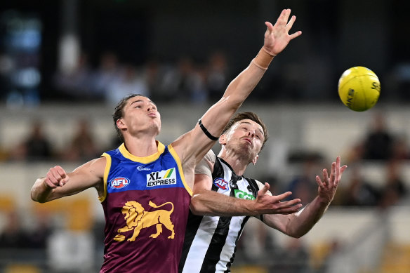 Brisbane's Eric Hipwood, who kicked two goals, and Jordan Roughead of the Magpies battle for the ball on Friday night. 