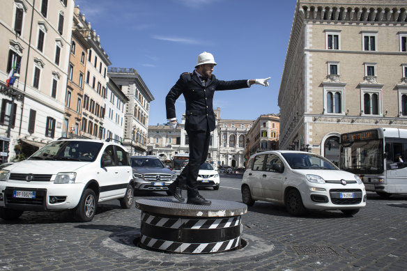 A veteran traffic officer, Pierluigi Marchionne, directs traffic on the Piazza Venezia in Rome this week.