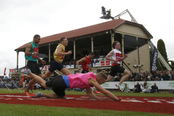 Tarrant (in white) wins as Nick Antonino falls over the line.