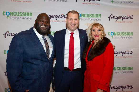Concussion Legacy Foundation founder Chris Nowinski (centre) with WWE Superstars Mark Henry and Lacy Evans at the annual Concussion Legacy Gala, in October 2019. 