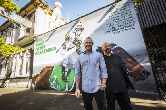 Brae Sokolski and Ozzie Kheir in front of a mural of Incentivise in South Melbourne before the 2021 Melbourne Cup.
