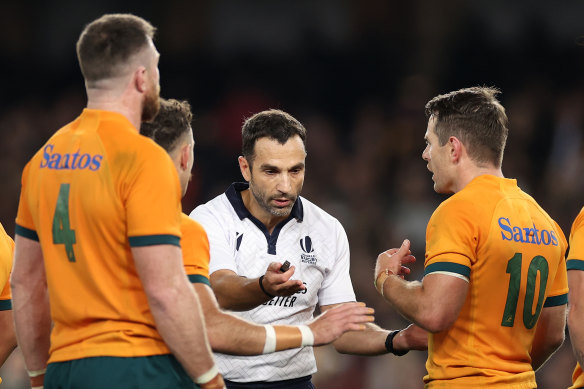 Power struggle: Referee Mathieu Raynal speaks to Nic White and Bernard Foley.