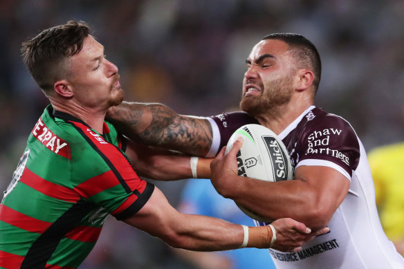 Former Rabbitoh Dylan Walker fends off Souths hooker Damien Cook in 2019. Manly and the Bunnies renew hostilities on Saturday.
