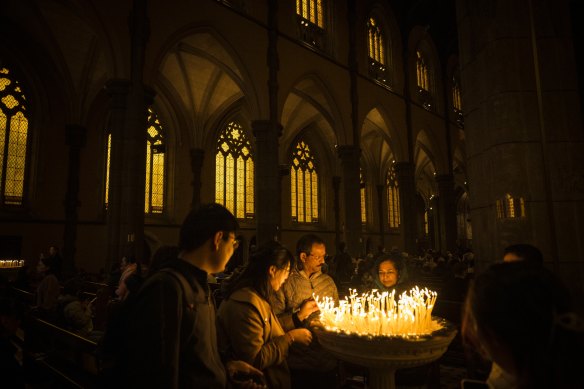 Candles are lit during the Easter Day mass at St Patrick’s Cathedral, Melbourne. 