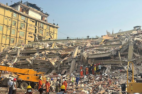 Rescuers work at the Sky Villa Condo that collapsed In Friday’s earthquake in Mandalay, Myanmar.