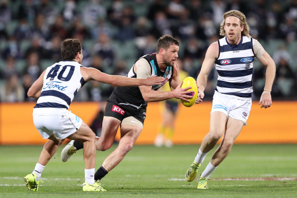 Port’s Travis Boak looks to run through Luke Dahlhaus and Cameron Guthrie.  