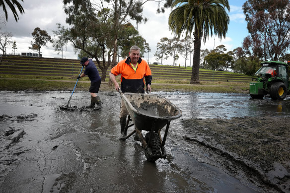 Peter Whelan cleaning the front of his house after the floods in Maribyrnong.