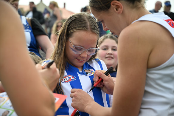 North’s Jasmine Garner signs autographs for fans after Sunday’s game.