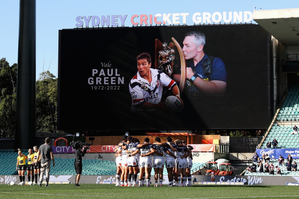 Cowboys players observe a minute of silence in memory of former coach Paul Green in 2022 after he took his own life.