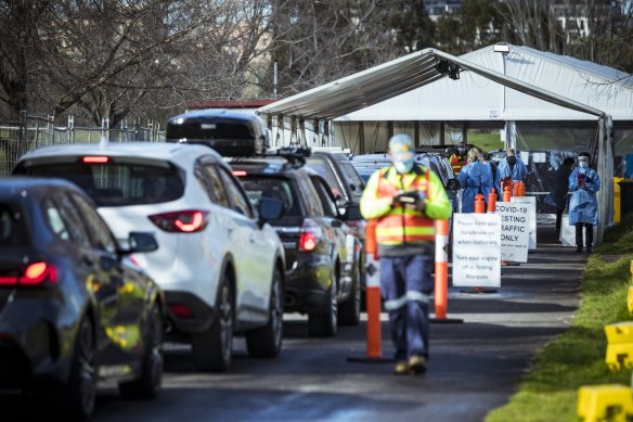 Long lines of people wait to get their COVID-19 test in Melbourne.