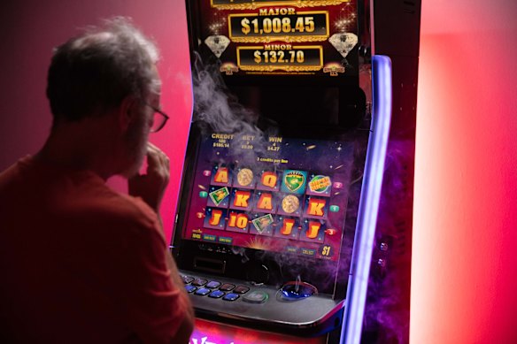 A player testing Walshe’s pokies machine, rigged with a losing sound on bets that didn’t clock a win.