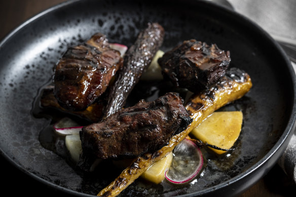 Slow-smoked pork cheeks with honey-ginger glaze and roasted root vegetables.