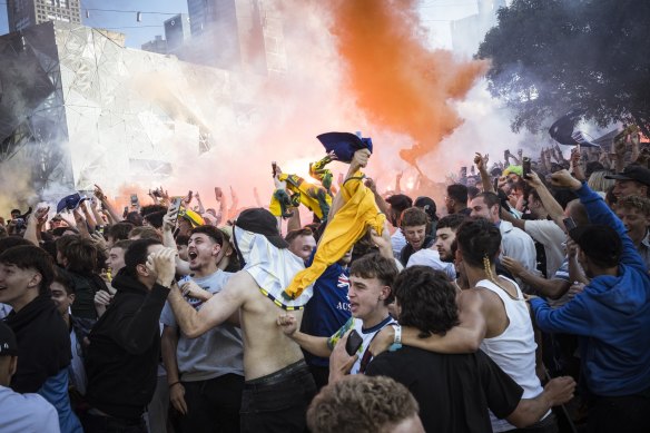 Soccer fans let off flares before watching Australia take on Argentina at Federation Square.