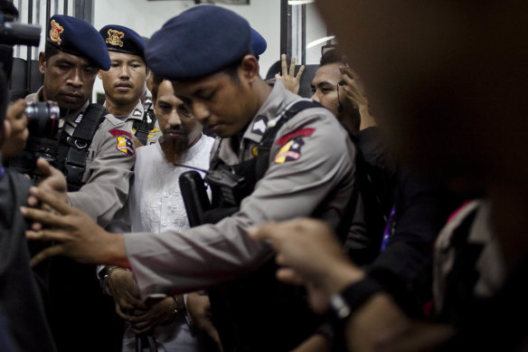 Umar Patek, centre, being escorted by police back in 2012. 