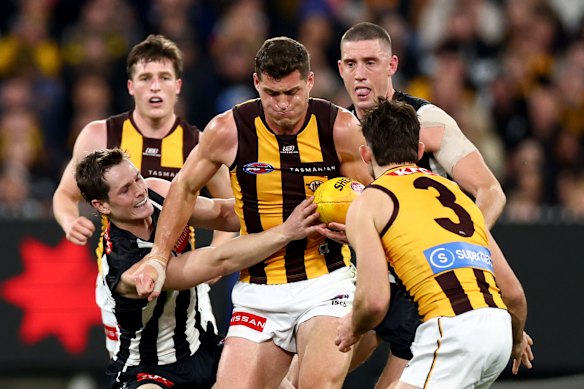 Collingwood’s Ned Long tackles Hawthorn’s Lloyd Meek.