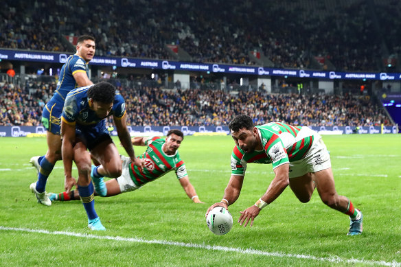 South Sydney winger Alex Johnston dives over for a try against Parramatta.