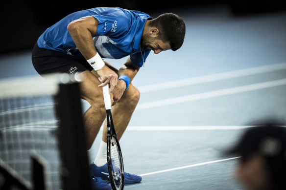 Novak Djokovic doubles over in pain.