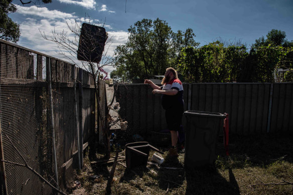 Jesse Knibbs clears the backyard of his South Windsor home of debris on Friday.