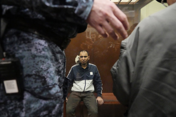 Saidakrami Murodali Rachabalizoda, a suspect in the Crocus City Hall shooting on Friday sits in a glass cage in the Basmanny District Court in Moscow, Russia.