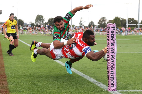 Alex Johnston denies Dragons winger Mikaele Ravalawa a try in the corner on Saturday.