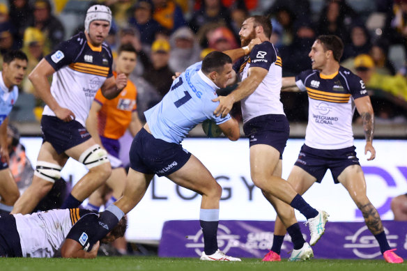 Dylan Pietsch of the Waratahs is tackled in Canberra