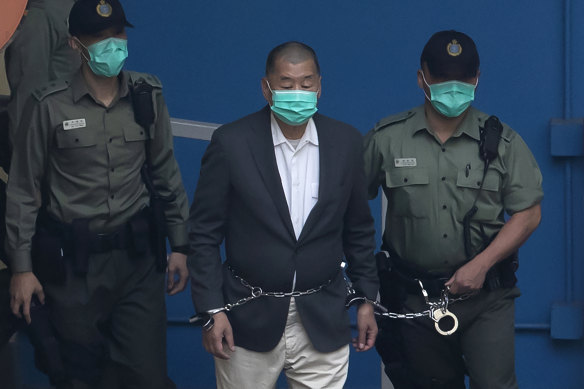 Jimmy Lai being led away in handcuffs in 2020. 