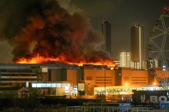 A massive blaze is seen over the Crocus City Hall on the western edge of Moscow after gunmen opened fire on a concert hall.