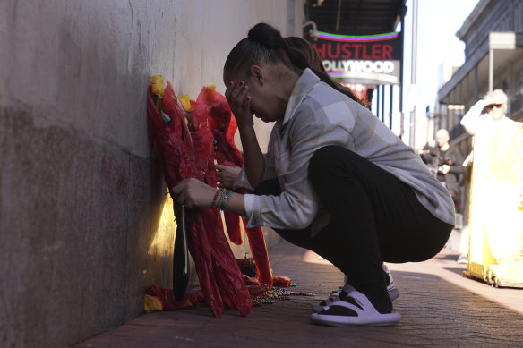 A woman places flowers at the scene of this week’s attack in New Orleans.