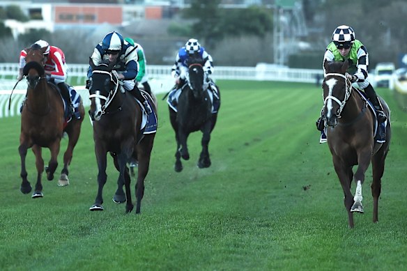 Jason Collett, right, wins down the outside fence on Travolta.