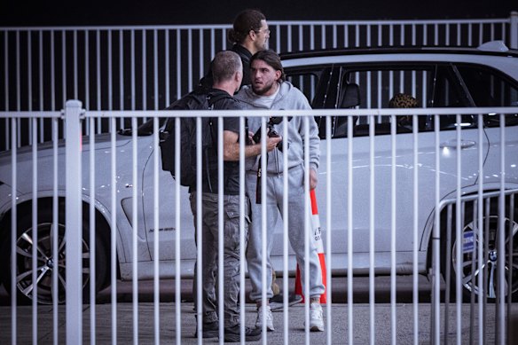 A man confronts a member of the media as Islamic State-linked families arrive at Melbourne International Airport.