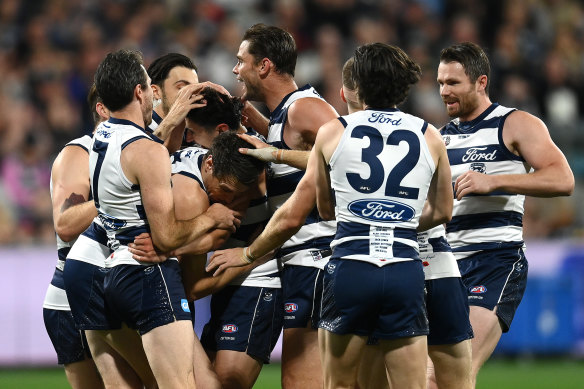 Sam Simpson is mobbed by teammates after kicking a goal in his comeback game.